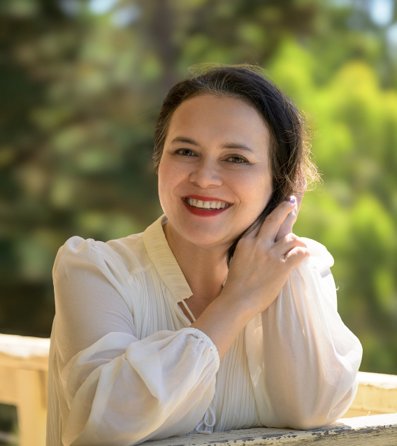Portrait of Pearl, a women’s holistic therapist in Healesville, smiling in a calm natural outdoor setting